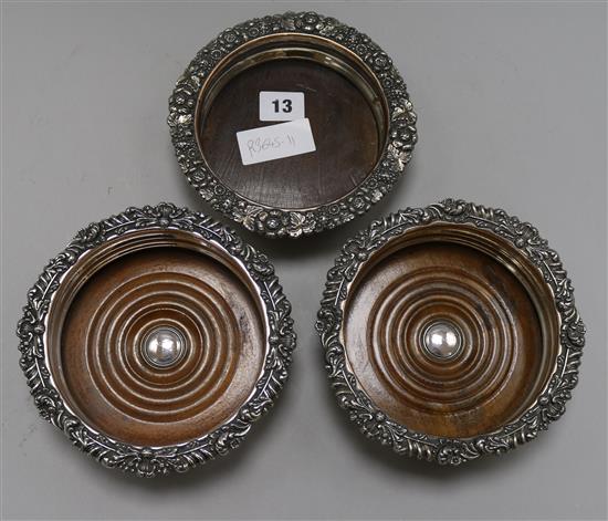 A pair of plated wine coasters and another